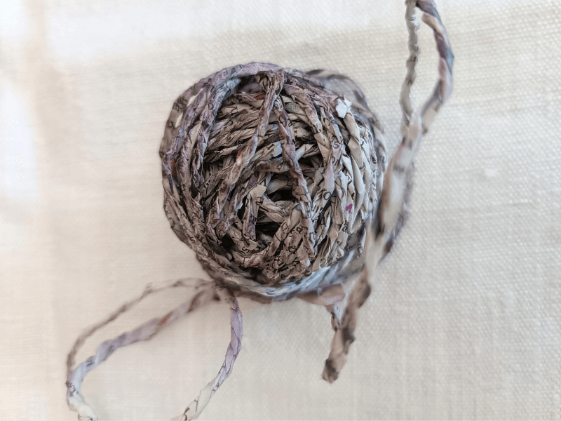 Nahaufnahme eines Knäuls Papiergarn aus Zeitung